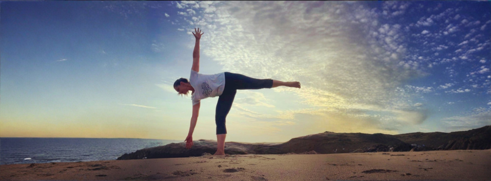 Donna Freeman doing half moon pose on the beach at sunrise in Cabo, Mexico.